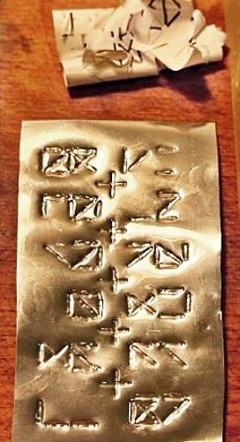 The completed seed plate with engraved glyphs.
